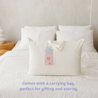 White pillow with a carrying bag on a bed, with text about the carrying bag.